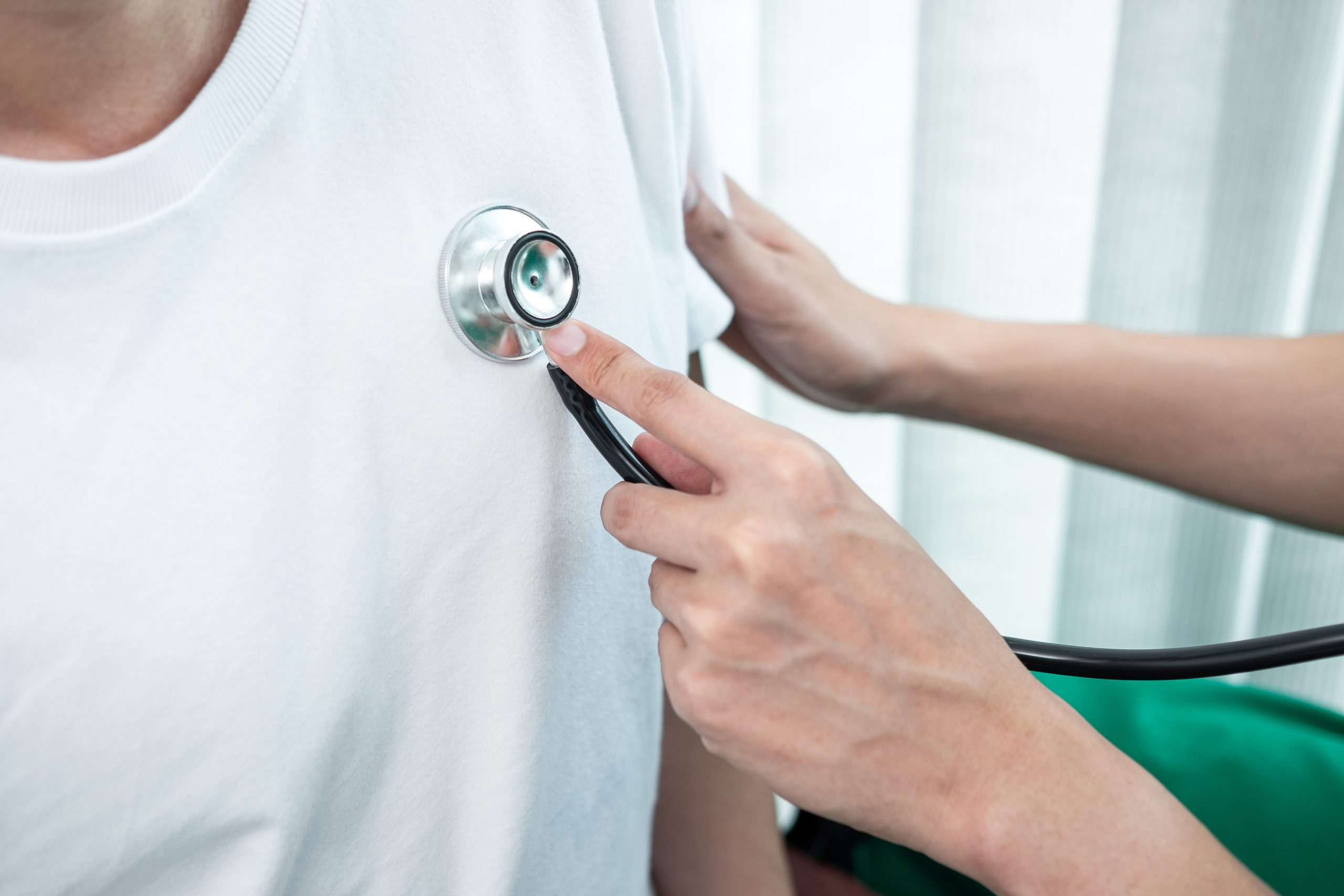 Doctor using a stethoscope checking patient about the problem of