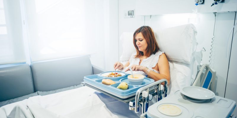 Sick woman eating in the hospital.